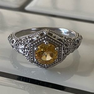 Beautiful fine detailed ring with yellow center stone.